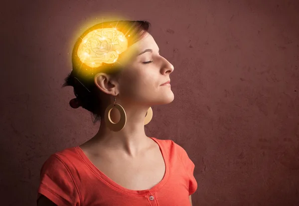 Young girl thinking with glowing brain illustration — Stock Photo, Image