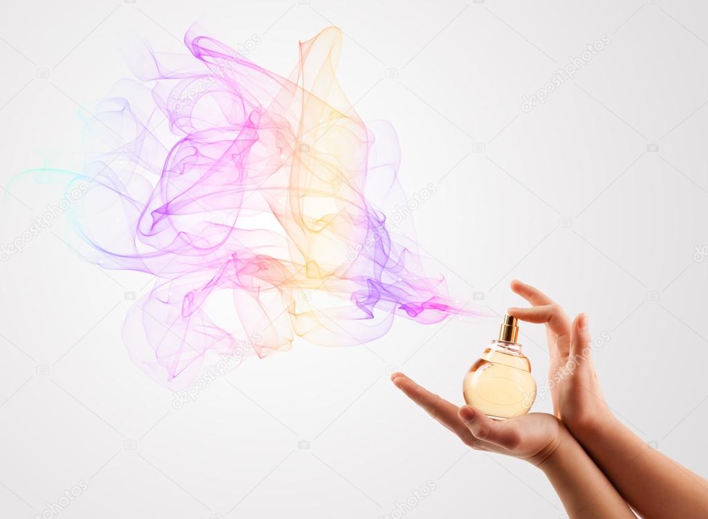 Woman hands spraying perfume