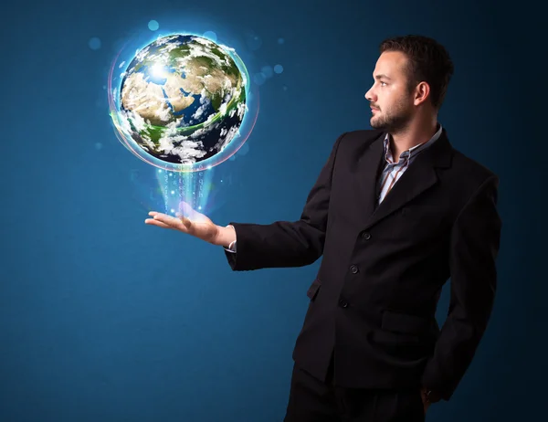 Businessman holding glowing earth globe — Stock Photo, Image