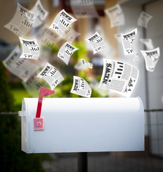 Post box with daily newspapers flying — Stock Photo, Image