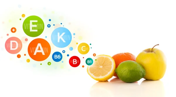 Healthy fruits with colorful vitamin symbols and icons — Stock Photo, Image