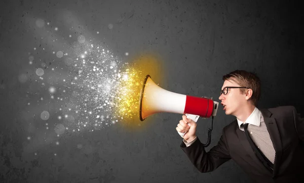 Guy shouting into megaphone and glowing energy particles explode — Stock Photo, Image