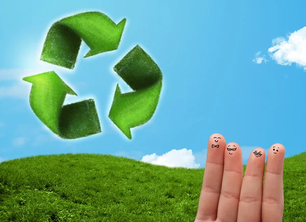 Happy smiley fingers looking at green leaf recycle sign — Stock Photo, Image