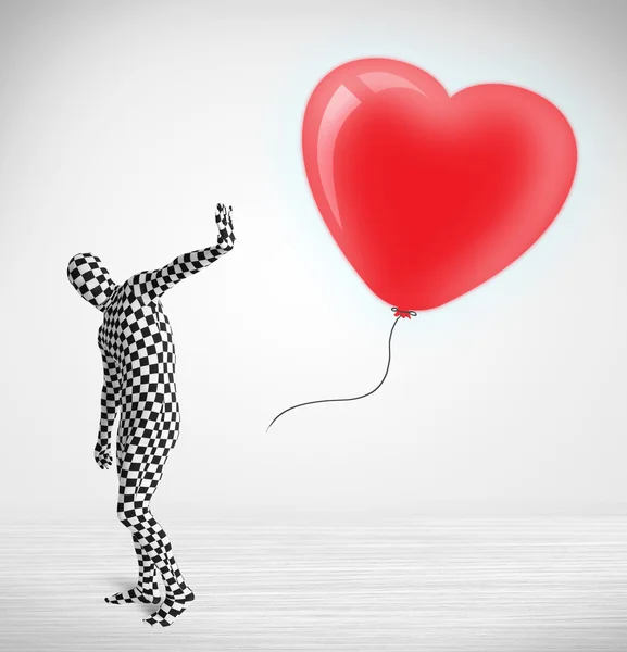 Cute guy in morpsuit body suit looking at a balloon shaped heart — Stock Photo, Image