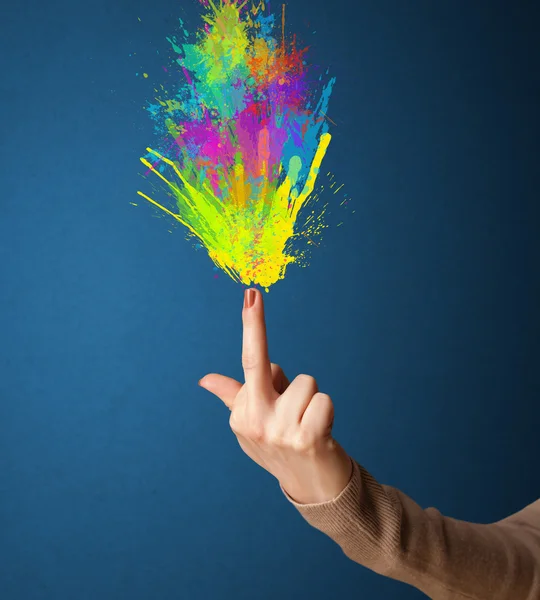 Colorful splashes are coming out of gun shaped hands — Stock Photo, Image