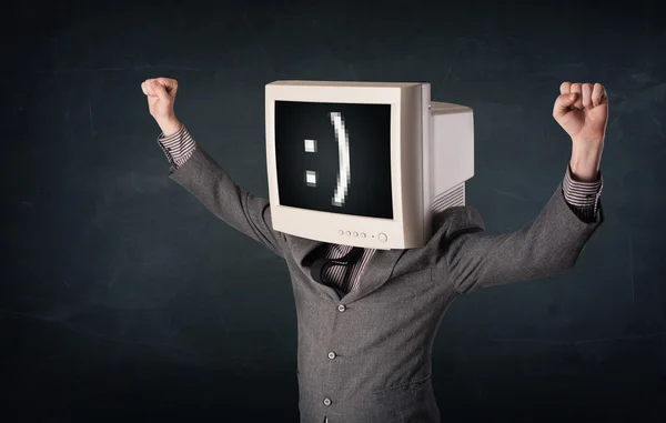 Divertente giovane uomo d'affari con un monitor sulla testa e smiley su — Foto Stock