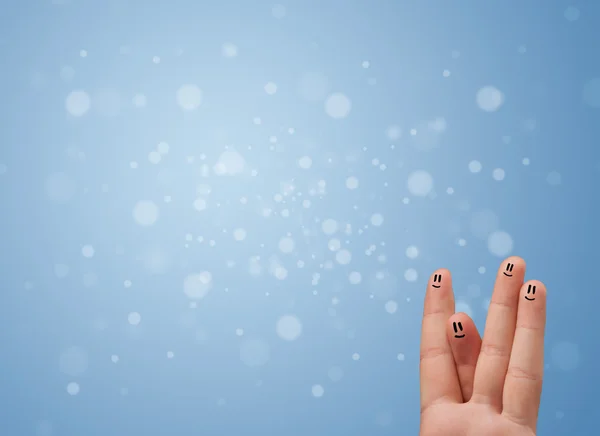 Happy finger smileys with empty blue bokeh background — Stock Photo, Image