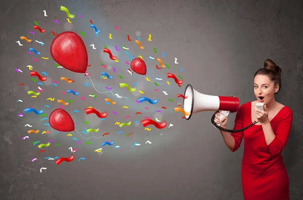 Young girl having fun, shouting into megaphone with balloons — Stock Photo, Image