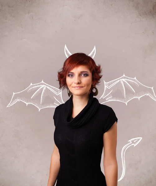 Young girl with devil horns and wings drawing — Stock Photo, Image