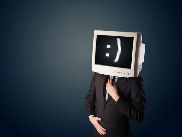 Grappige jonge zakenman met een monitor op zijn hoofd en smiley op — Stockfoto