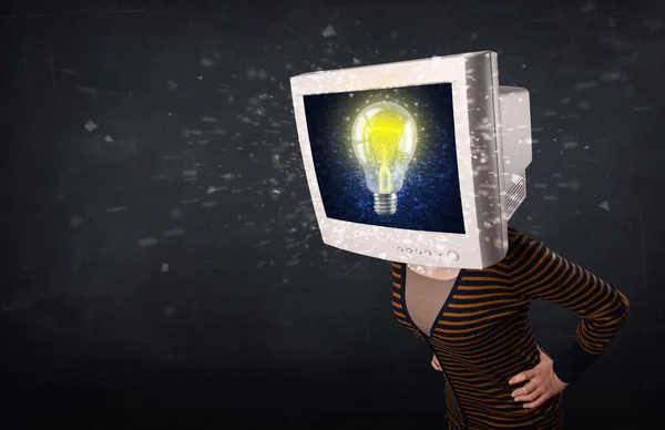 Girl with a monitor head, idea light bulb — Stock Photo, Image