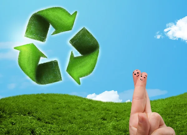 Happy smiley fingers looking at green leaf recycle sign — Stock Photo, Image