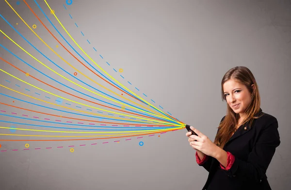 Happy girl holding a phone with colorful abstract lines — Stock Photo, Image