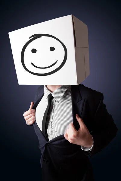 Businessman gesturing with a cardboard box on his head with smil — Stock Photo, Image