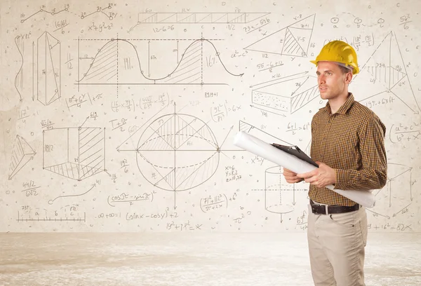 Ingeniero guapo calculando con fondo dibujado a mano — Foto de Stock