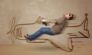 Duvara el çizimi uçak süren komik pilot.