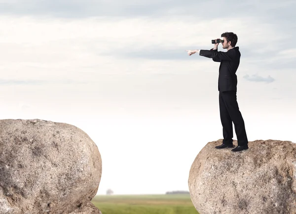 Businessman on rock mountain — Stock Photo, Image