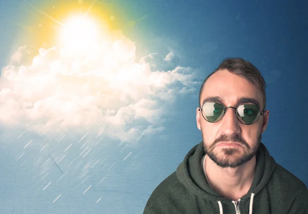 Young person looking with sunglasses at clouds and sun — Stock Photo, Image