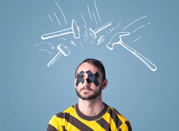 Young man with glued eye and hammer marks — Stock Photo, Image