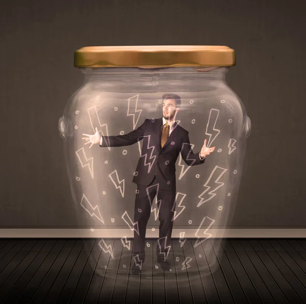 Businessman inside a glass jar with lightning drawings concept — Stock Photo, Image