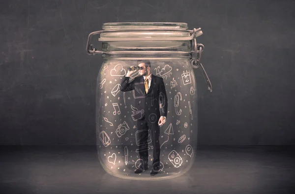 Business man captured in glass jar with hand drawn media icons c — Stock Photo, Image