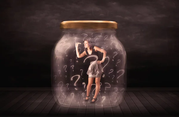 Businesswoman locked into a jar with question marks concept — Stock Photo, Image