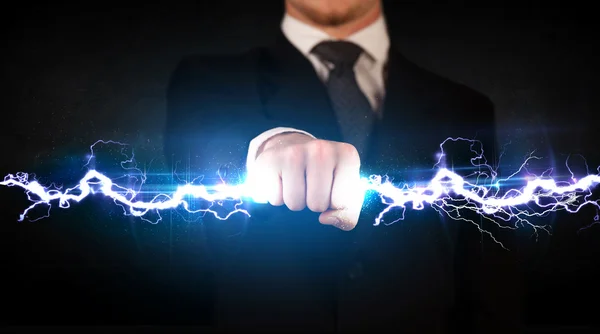 Zakenman houdt elektriciteit licht bout in zijn handen — Stockfoto
