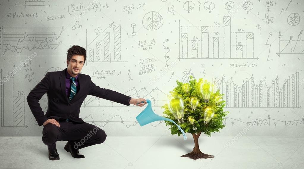 Business man pouring water on lightbulb growing tree