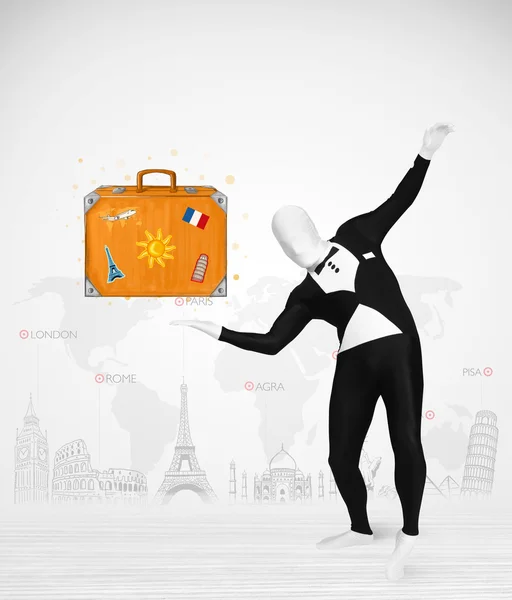 Man in full body suit presenting vacation suitcase — Stock Photo, Image