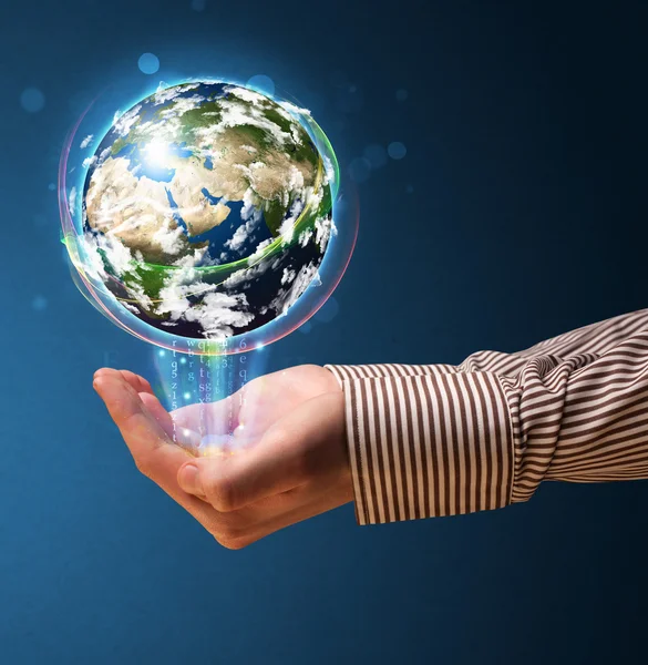 Businessman holding a glowing earth globe — Stock Photo, Image