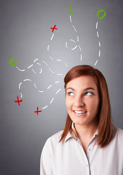 Jonge vrouw denken met abstracte kenmerken overhead — Stockfoto