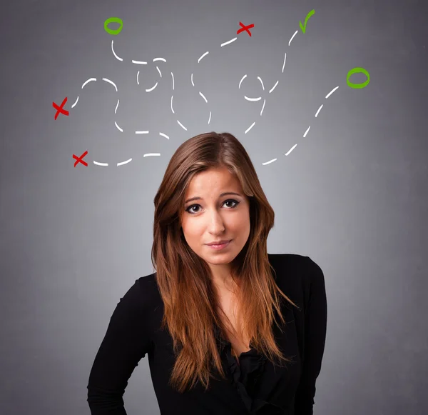 Young woman thinking with abstract marks overhead — Stock Photo, Image