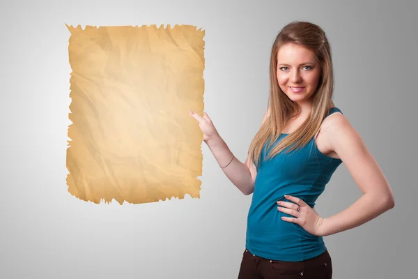 Young girl presenting old paper copy space — Stock Photo, Image