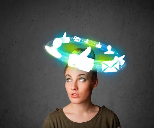 Young teenager with cloud social icons around her head — Stock Photo, Image