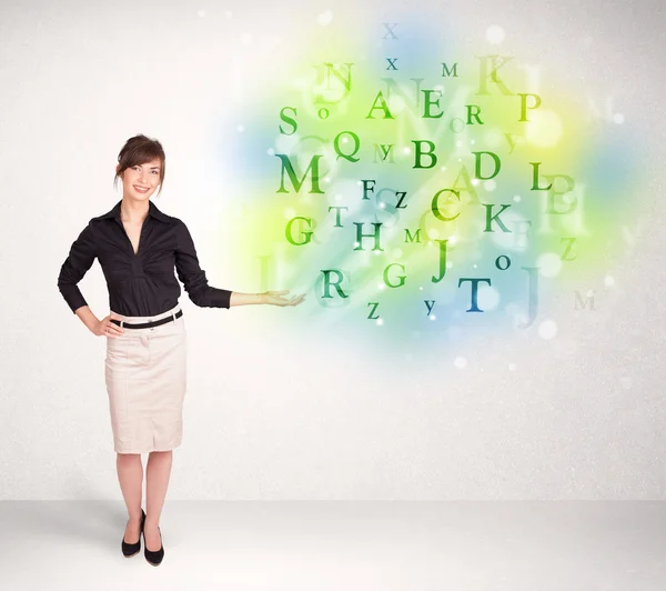 Business women with glowing letter concept — Stock Photo, Image