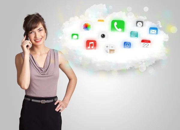 Young woman presenting cloud with colorful app icons and symbols — Stock Photo, Image