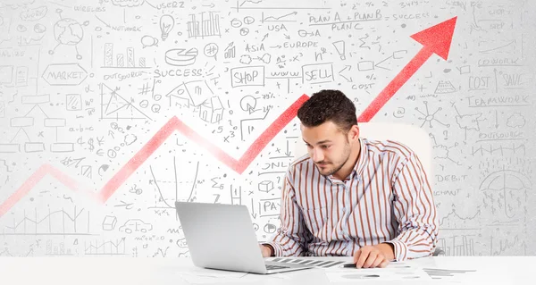 Business man sitting at table with market diagrams — Stock Photo, Image