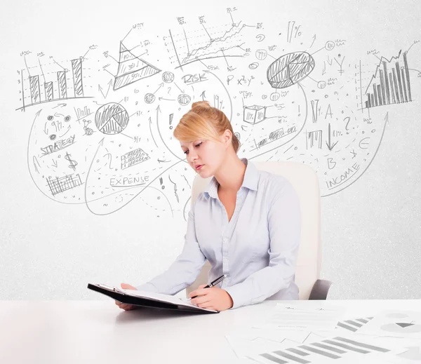 Business woman at desk with hand drawn charts — Stock Photo, Image