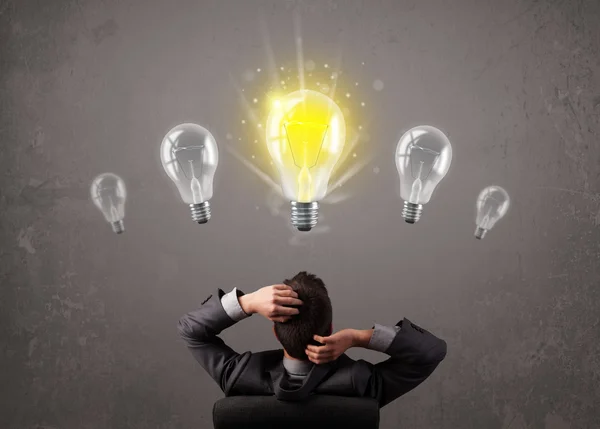 Business person having an idea light bulb concept Stock Picture