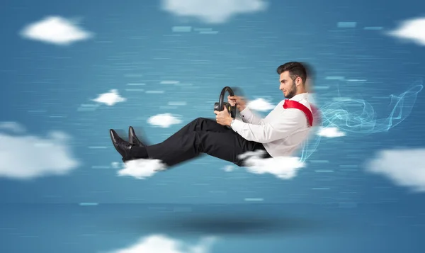 Funny racedriver young man driving between clouds concept — Stock Photo, Image