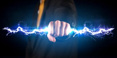 Business man holding electricity light bolt in his hands