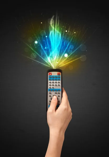 Hand with remote control and explosive signal — Stock Photo, Image