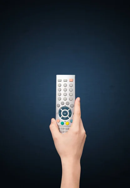 Hand with remote control — Stock Photo, Image