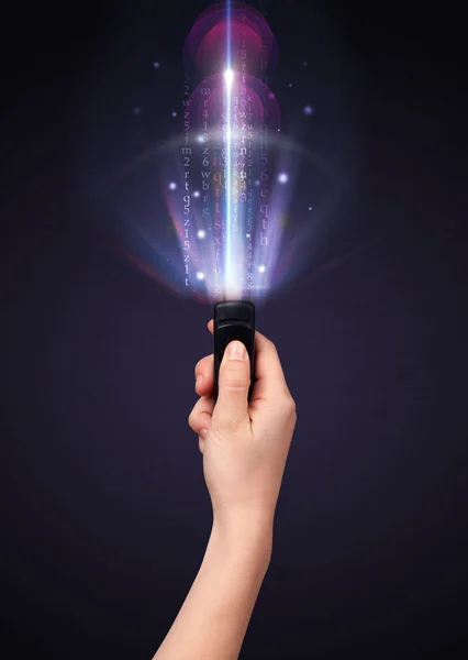 Hand with remote control and shining numbers — Stock Photo, Image