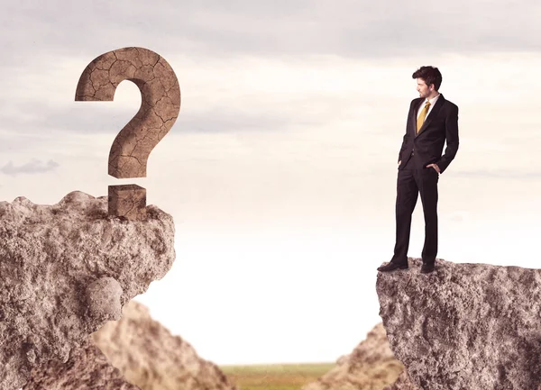 Businessman on rock mountain with a question mark — Stock Photo, Image