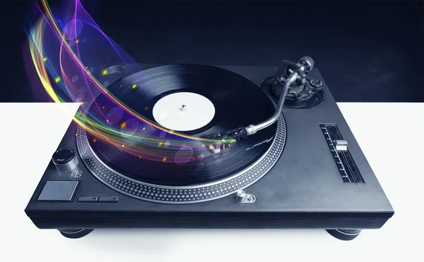 Turntable playing vinyl with glowing abstract lines — Stock Photo, Image