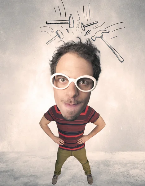 Big head person with drawn hammers — Stock Photo, Image