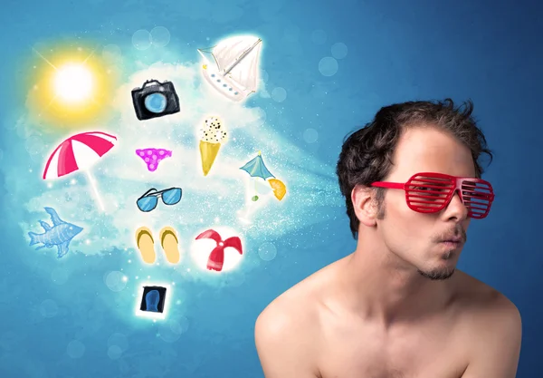 Güneş gözlüklü mutlu adam yaz ikonlarına bakıyor. — Stok fotoğraf