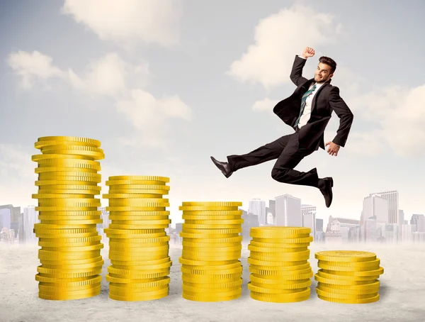 Successful business man jumping up on gold coin money — Stock Photo, Image