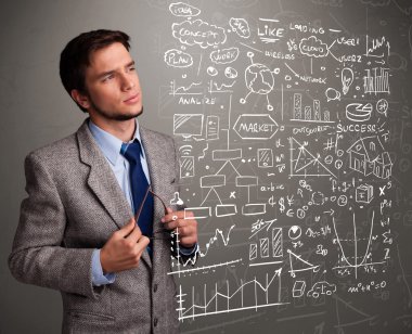 Borsa grafiklerine ve sembollerine bakan çekici bir adam.